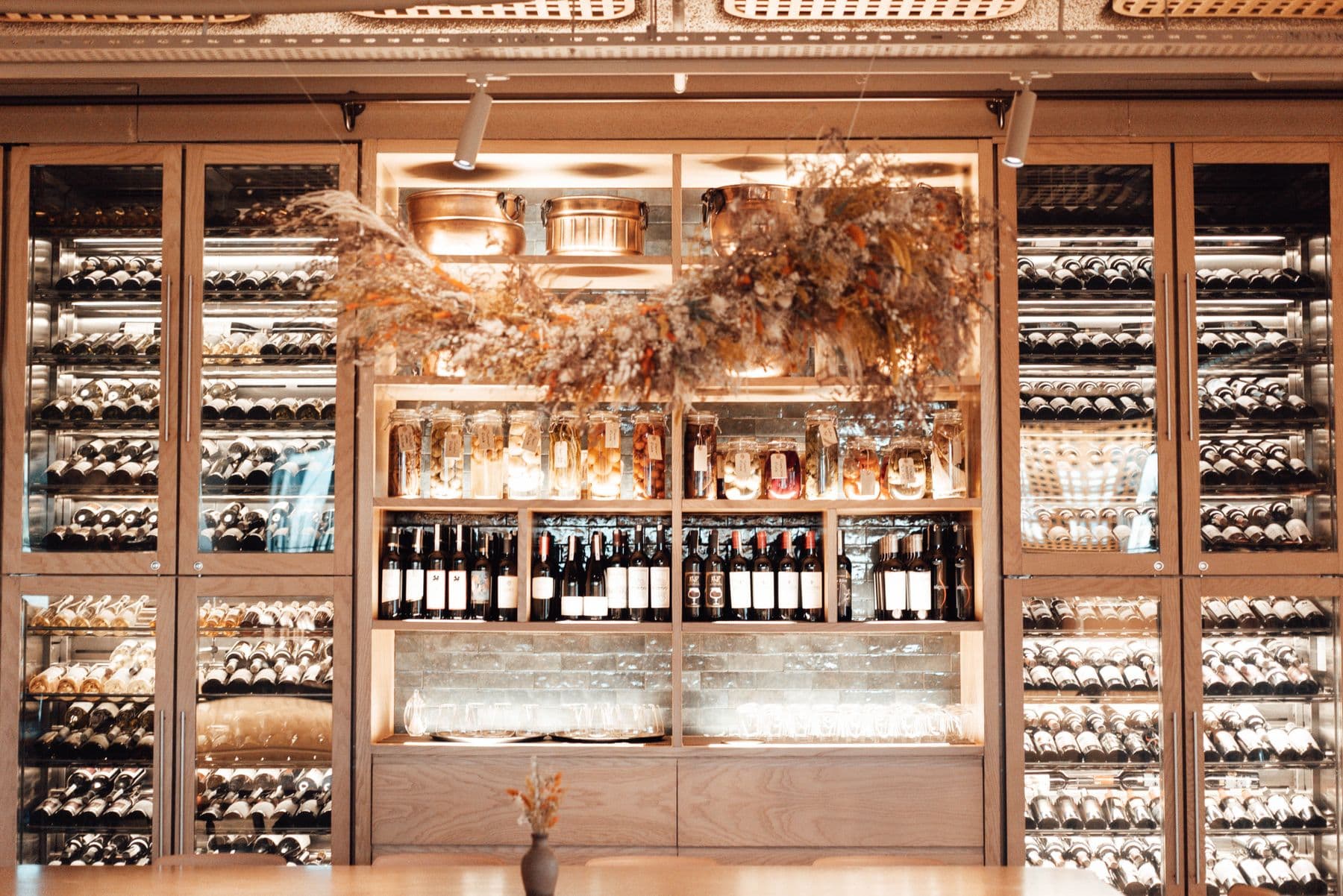 The Cellar & Stack wine wall, warmly lit